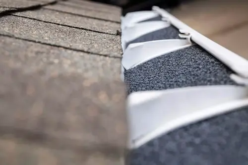 Foam gutter insert showing organic buildup and deterioration — this type becomes a moss incubator in BC's coastal climate within one to two seasons